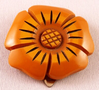 BP46 butterscotch bakelite flower dress clip